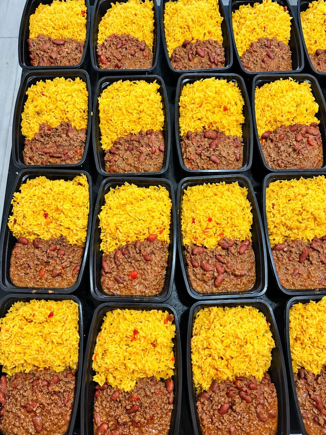 Trays of yellow rice with beans and beef
